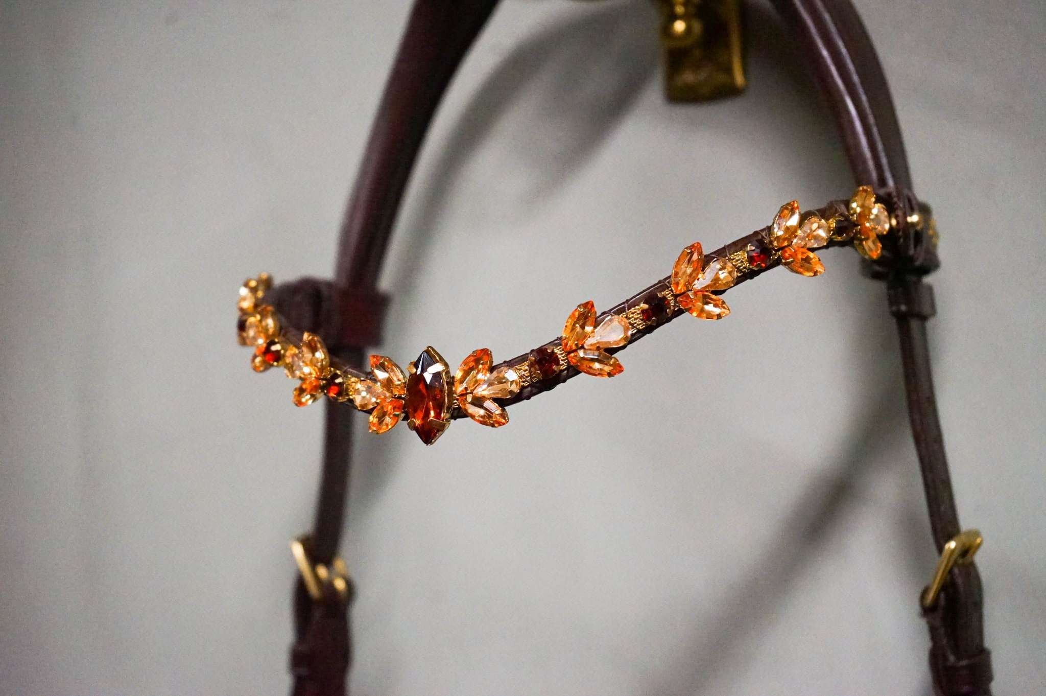 Bronze Elegance soft leather hand-stitched accessory with crystal chain and brass hardware