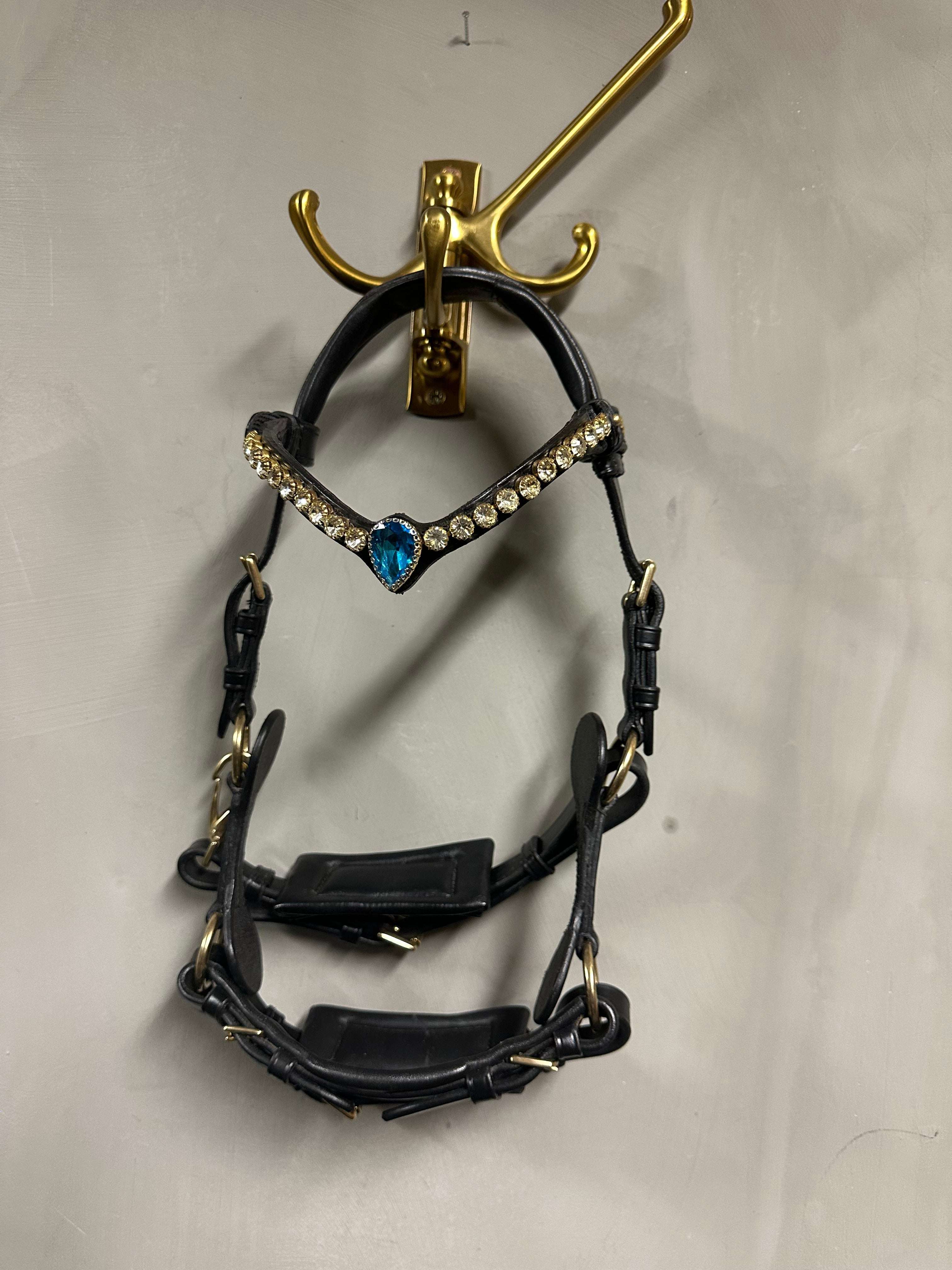Mini-Shetty sidepull in black leather with brass hardware and soft padding, adjustable nose, chin, and cheek.