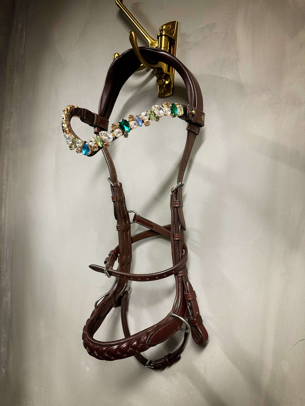 Odessa Bonita Multi bridle padded with MASEGO bit to bitless system in silver, decorated with multicolored stones hanging on wall hook