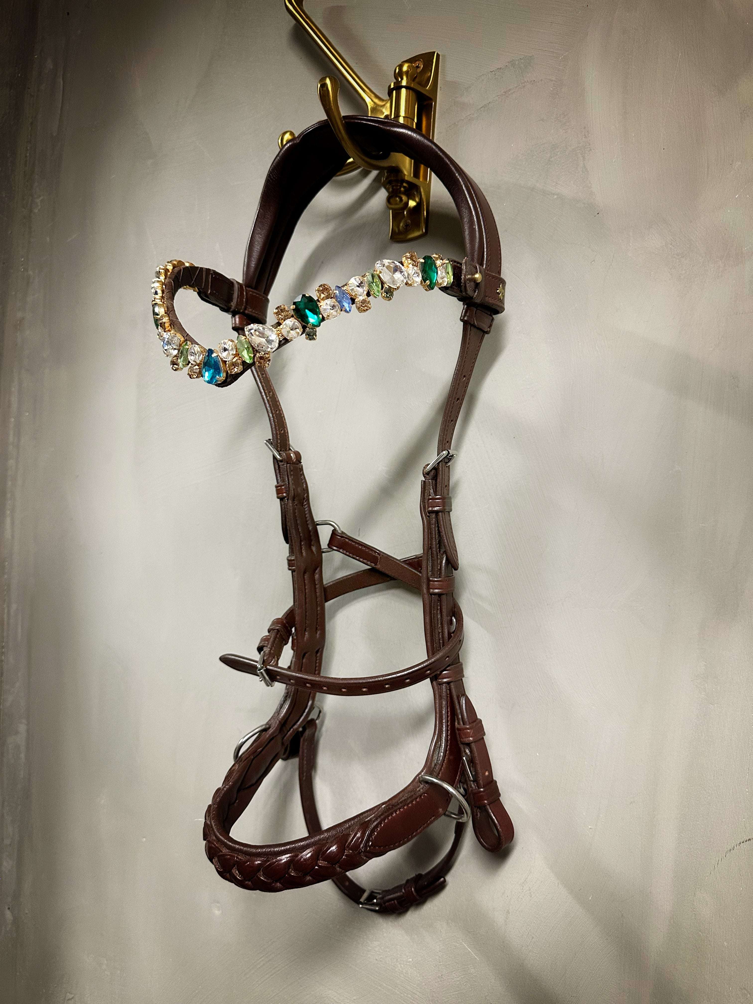 Odessa Bonita Multi bridle padded with MASEGO bit to bitless system in silver, decorated with multicolored stones hanging on wall hook