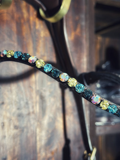 Close-up of a blue mint browband adorned with vibrant 8mm colored stones and a quick-release clasp for equestrian gear.