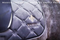 Grey velvet dressage saddle pad with black piping and beige gold logo in velvet-like material full size