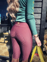 Load image into Gallery viewer, Burgundy Masego Riding Tights with full seat silicone grip and high waist worn by woman outdoors
